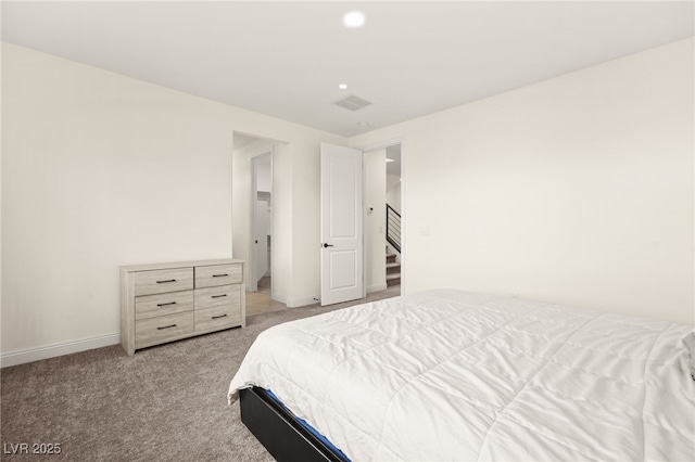 bedroom with visible vents, baseboards, and light colored carpet