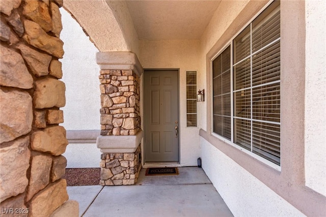 property entrance featuring stone siding