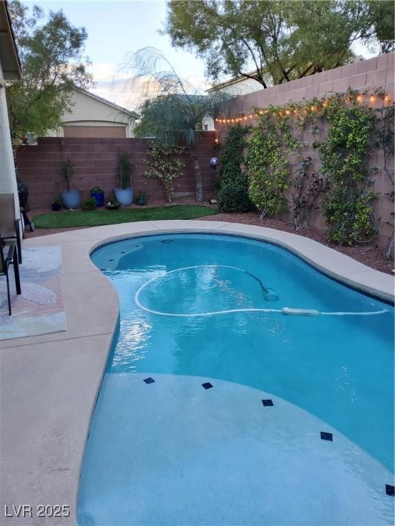 view of pool with a fenced backyard