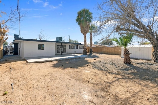 rear view of property featuring central AC, stucco siding, french doors, a fenced backyard, and a patio