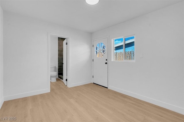 foyer with light wood-type flooring and baseboards