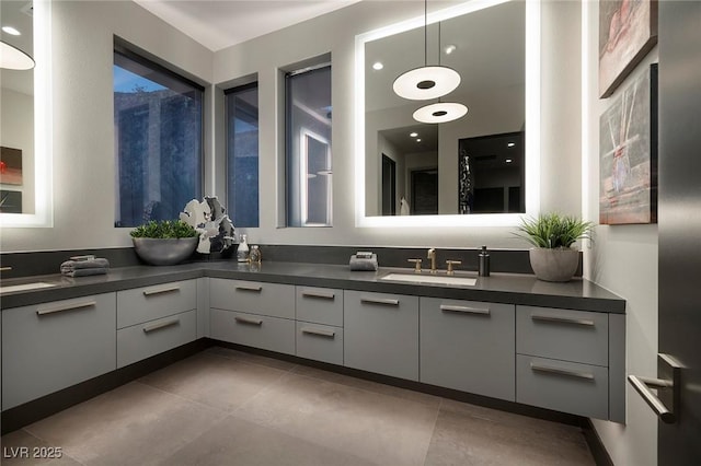 full bath featuring a sink, double vanity, and tile patterned flooring