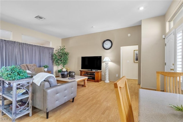 living area featuring recessed lighting, visible vents, and light wood finished floors