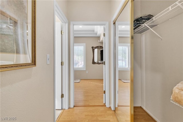 hall with baseboards and light wood-type flooring