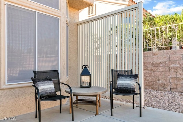 view of patio / terrace featuring fence