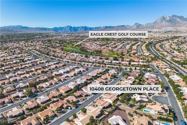 birds eye view of property with a mountain view and a residential view