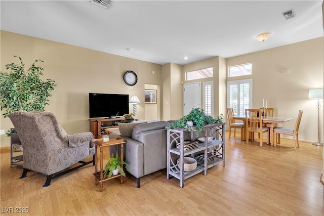 living room featuring visible vents and light wood finished floors