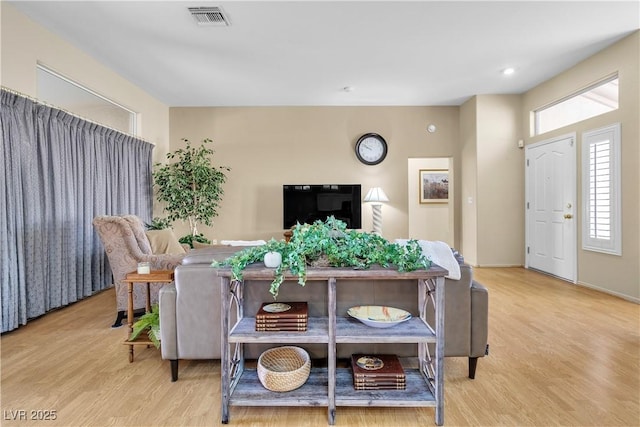 dining space with wood finished floors and visible vents