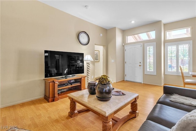 living room featuring baseboards and light wood-style floors