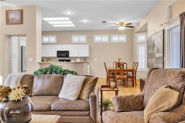 living area featuring recessed lighting, visible vents, light wood finished floors, and ceiling fan