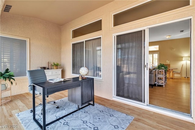 office space featuring visible vents and wood finished floors