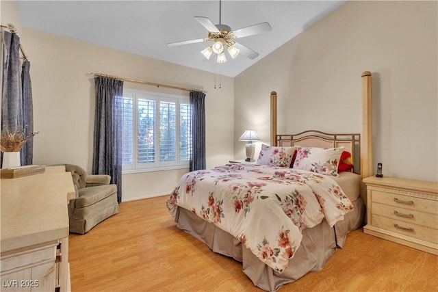 bedroom featuring light wood-style floors, a ceiling fan, and vaulted ceiling