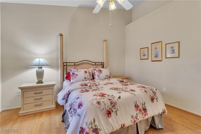 bedroom with light wood-style floors, baseboards, and ceiling fan