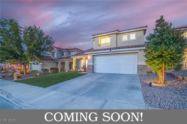 view of front of home with a tile roof, stucco siding, a garage, stone siding, and driveway