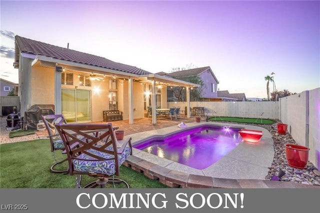 view of pool featuring a lawn, area for grilling, a patio, a fenced backyard, and a fenced in pool