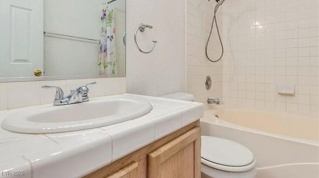 full bathroom featuring toilet, vanity, and shower / bathtub combination with curtain