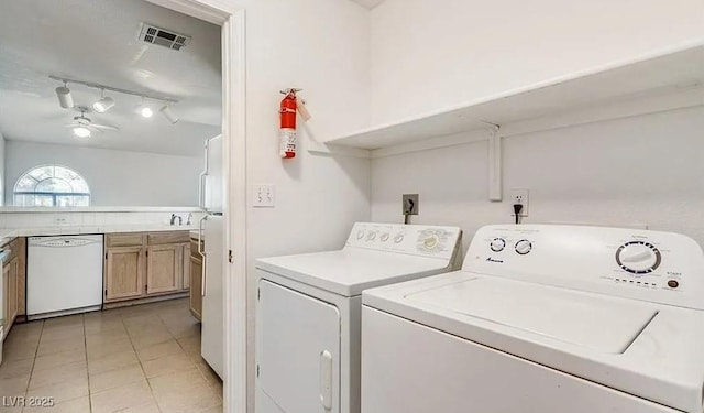 laundry room with visible vents, rail lighting, light tile patterned floors, ceiling fan, and washing machine and clothes dryer