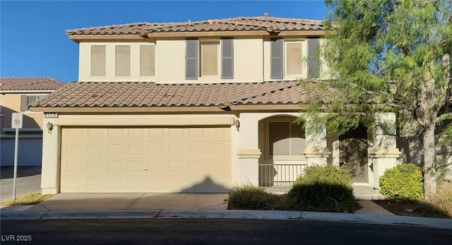 mediterranean / spanish-style house featuring stucco siding, driveway, a tile roof, and a garage