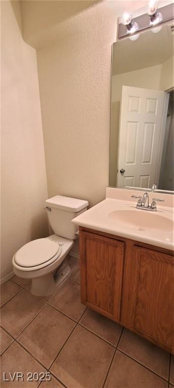 bathroom with vanity, tile patterned floors, and toilet