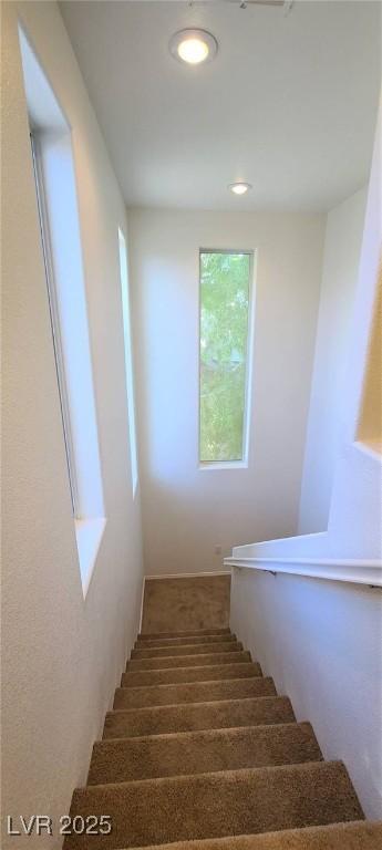 staircase with recessed lighting