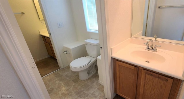 bathroom featuring toilet and vanity