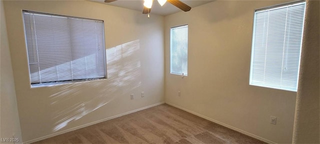 unfurnished room with baseboards, a ceiling fan, and carpet floors