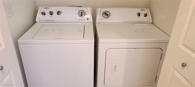 laundry area with separate washer and dryer and laundry area