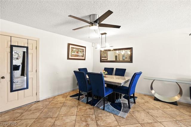 tiled dining room with baseboards, a textured ceiling, and a ceiling fan