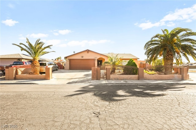 view of front of house featuring a fenced front yard, a garage, concrete driveway, and stucco siding