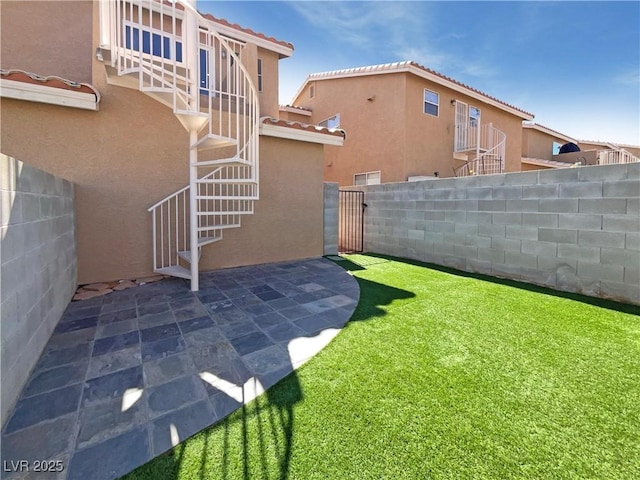 view of yard featuring stairway, a patio, and fence