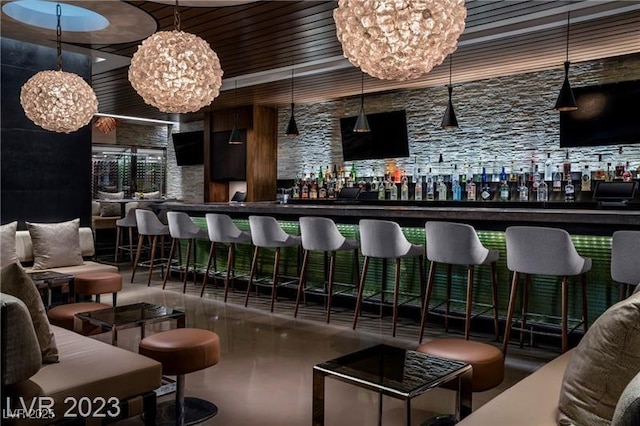 bar featuring a notable chandelier and a dry bar