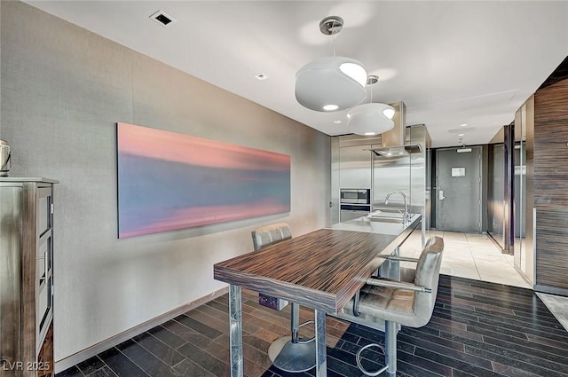 dining area featuring visible vents and light wood finished floors