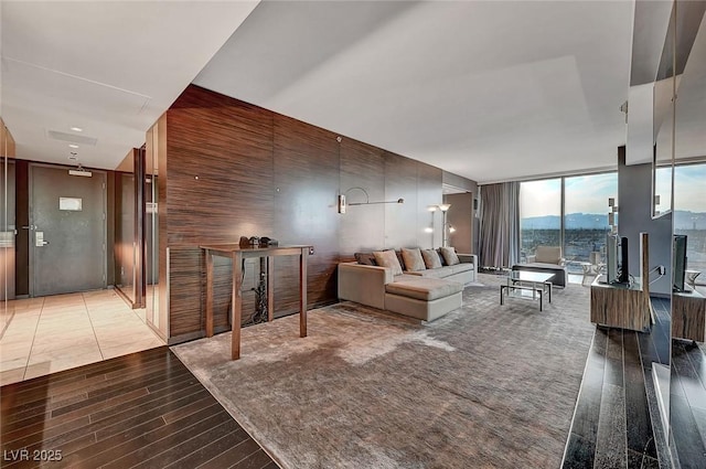 living room with light wood finished floors and floor to ceiling windows