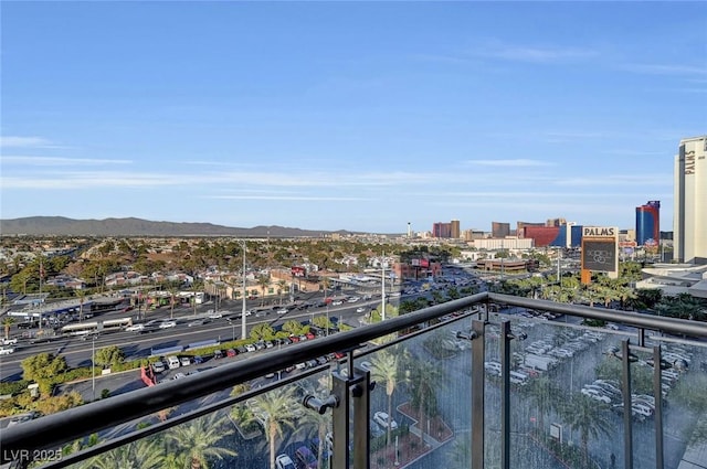 balcony with a mountain view and a view of city