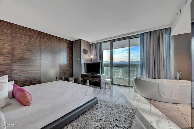 bedroom featuring access to exterior and expansive windows