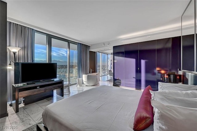 bedroom with expansive windows, marble finish floor, and access to exterior