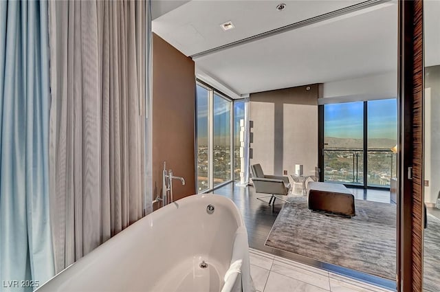 full bath with a freestanding tub and expansive windows