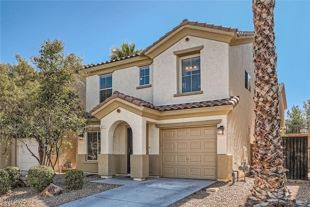 mediterranean / spanish house featuring stucco siding, driveway, fence, an attached garage, and a tiled roof