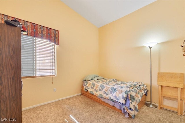 bedroom featuring vaulted ceiling, baseboards, and carpet floors