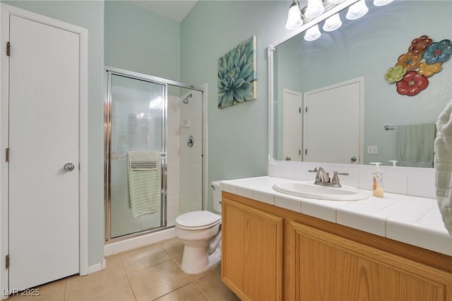 bathroom with tile patterned floors, a stall shower, toilet, and vanity