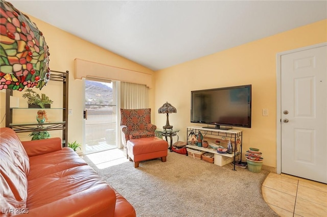 living area with tile patterned floors, carpet, and lofted ceiling