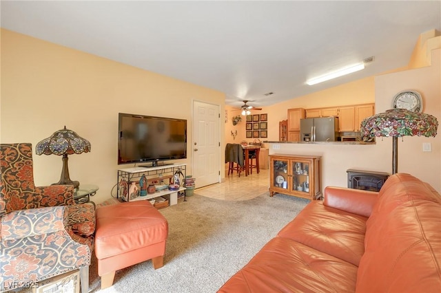 living room with visible vents, ceiling fan, light colored carpet, lofted ceiling, and light tile patterned floors