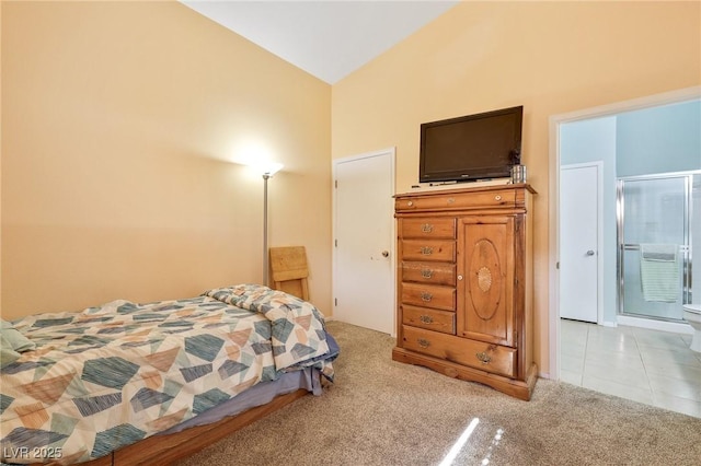 bedroom with light tile patterned floors, light colored carpet, and vaulted ceiling