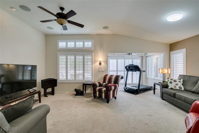 carpeted living area featuring lofted ceiling, plenty of natural light, and ceiling fan