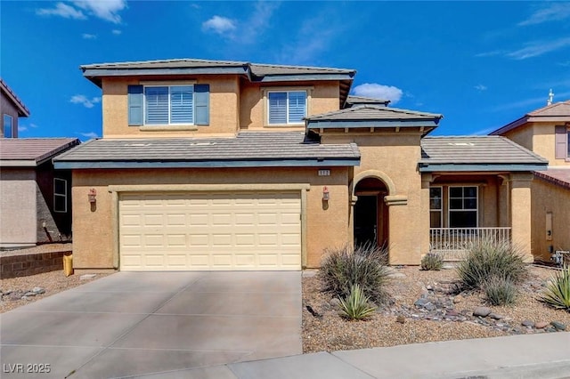 view of front of house with concrete driveway, a tile roof, a garage, and stucco siding