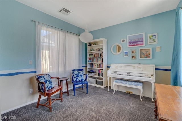 living area featuring visible vents, baseboards, and carpet floors