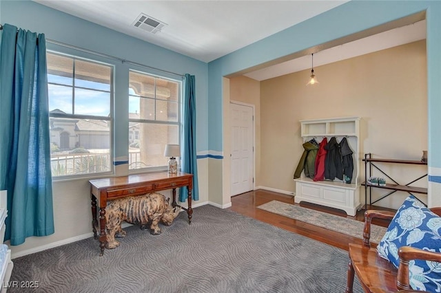 entryway with visible vents, baseboards, and wood finished floors