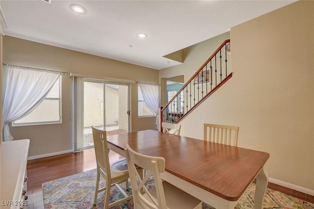 dining area featuring a wealth of natural light, stairway, and baseboards