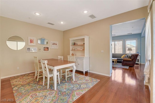 dining space with recessed lighting, visible vents, baseboards, and wood finished floors