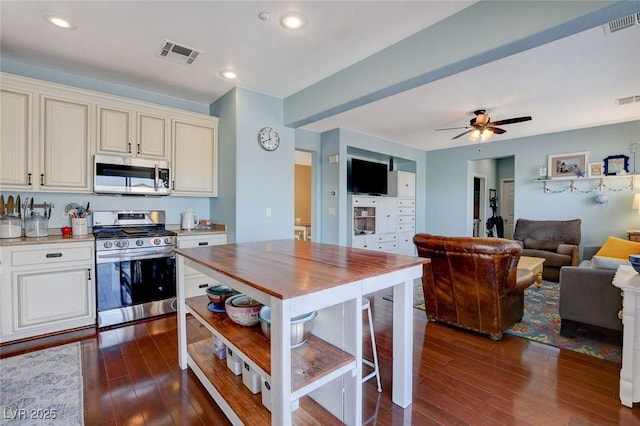 kitchen featuring visible vents, appliances with stainless steel finishes, and dark wood-style floors